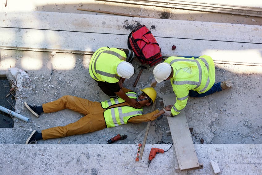 Check Response and pulse, Life-saving and rescue methods. Accident at work of builder worker at Construction site. Heat Stroke or Heat exhaustion in body while outdoor work.