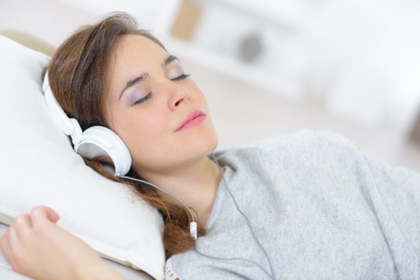 woman wearing headphones and sleeping.